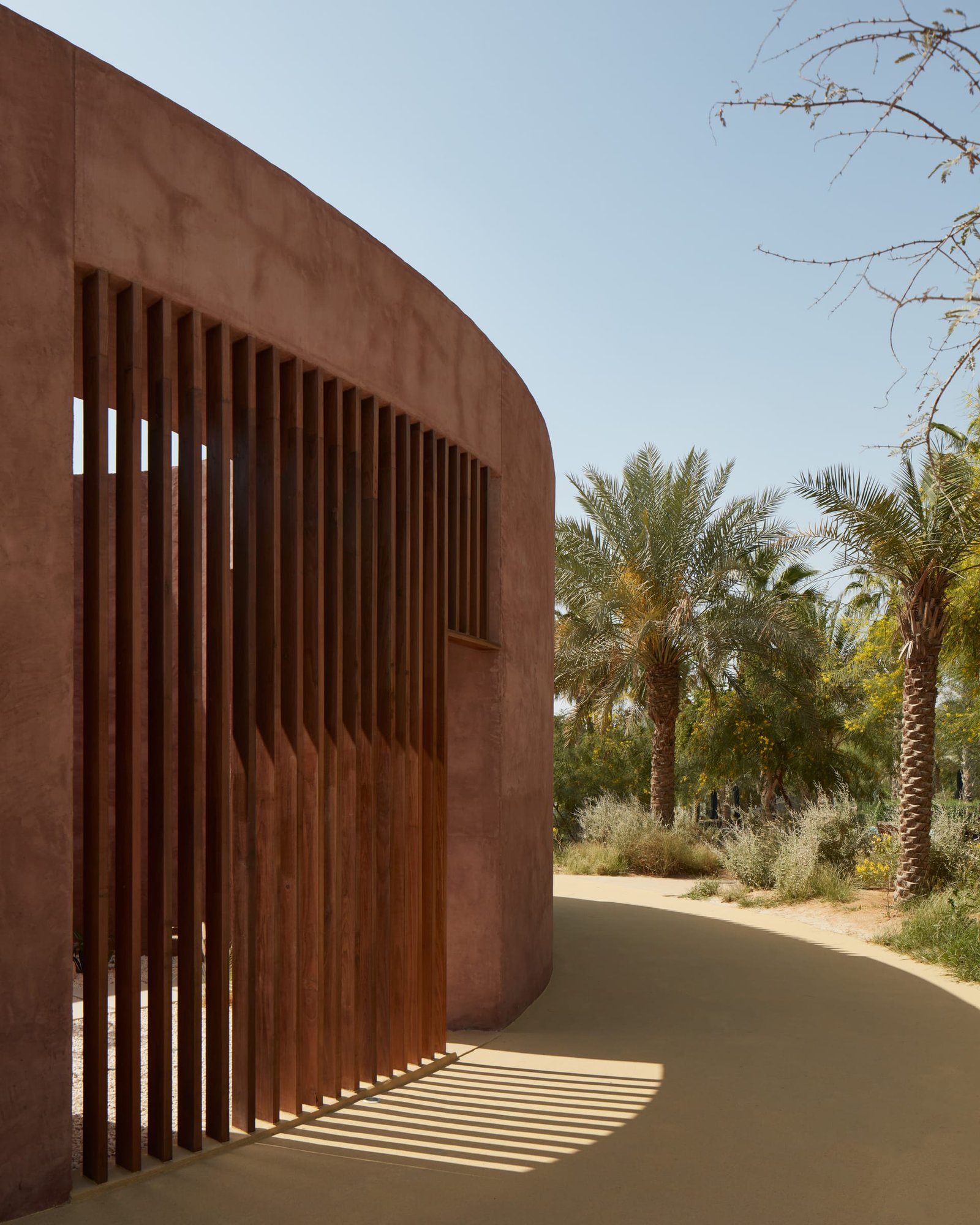Curved white exterior clay plaster facade at the Canvas Events Pavilion, Dubai